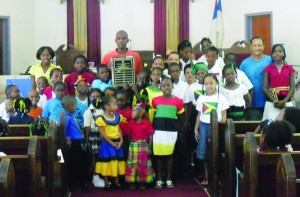 Commonwealth Games athlete, Kirthly Richardson (centre), presents the Commonwealth Sports Day Shield to Blue House at Central Christian School.