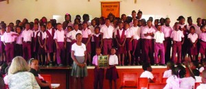 Commonwealth Games athletes, Jonicia Richardson, presents the Commonwealth Sports Day Shield to Red House at Orealia Kelly Primary School.