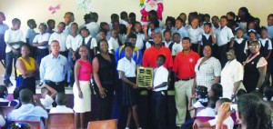 Commonwealth athletes, Brian Richardson (left), Kirthly Richardson (centre), Ronnie Bryan (right), present the Commonwealth Sports Day Shield to Green House at Adrian T. Hazell Primary School.