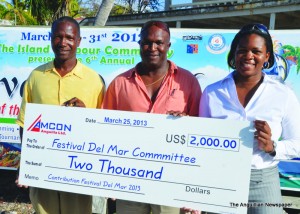 Mr. Vanterpool receiving cheque from Lanvil Harrigan and Yvette Harrigan