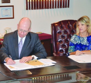 Governor Harrison initialling FFSD with  Mrs. Kim Cutler 