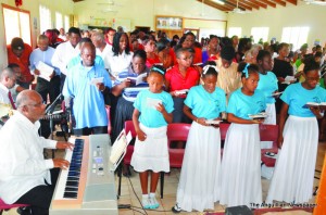 Reverend Lindsay Richardson (at keyboard) with congregation in song