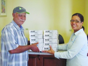 Kenneth Harrigan accepts digital set-top boxes from Ms. Sylvia Rogers