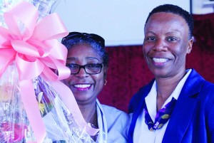 Ms. Veda Harrigan receiving presentation from Mrs. Ornette Edwards-Gumbs