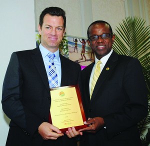 From left, winner of “Best Broadcast Feature” Loren Christie, for his CTV news story showcasing destination weddings in Anguilla with CTO Secretary General Hugh Riley during Caribbean Media Awards Luncheon in Toronto