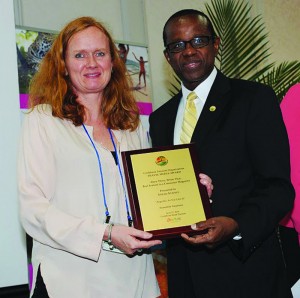 From left, winner of “Best Feature Article in a Consumer Magazine” Sarah Staples for her Ensemble Vacations magazine story “Anguilla As You Like It” with CTO Secretary General Hugh Riley during Caribbean Media Awards Luncheon in Toronto