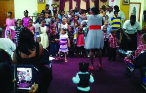 "VBS Children being directed in theme song by Tr. Annishka"