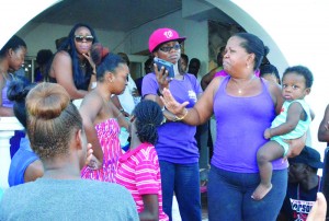 Ms. Simone Connor (Sister of Silwood Connor) addressing crowd outside her family's residence at Blowing Point