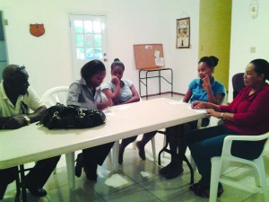 Ms Lauraine Gumbs from the Department of Social Development (second from left) speaking with young ladies who are Job Link-Up clients and parents