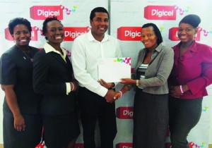 Digicel Country Manager, John Gidharry, presents Anguilla Cancer Society’s President, Jennifer Gumbs, with a US$1,000 cheque in support of their mammogram screening drive.