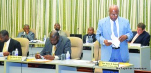 Government Side of the House of Assembly (prior to the departure of Deputy Speaker, Acting Deputy Governor and Attorney General). Chief Minister Hughes introducing Bills