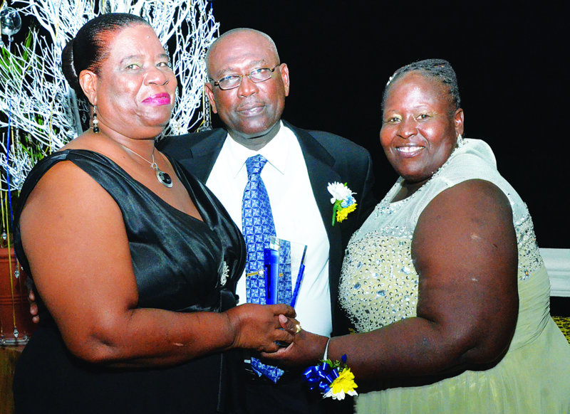 Mrs Celestine John and Emma Ferguson presenting award to Mr. Rodney Rey