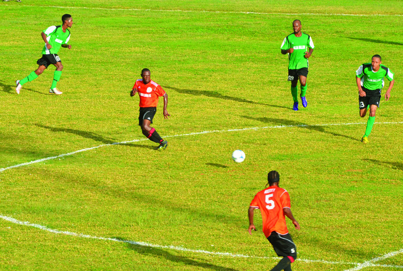 AMERICAN FOOTBALLER PRESENTS CLEATS FOR ANGULLIAN PLAYERS