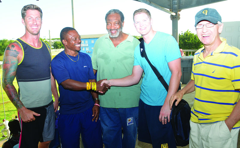 AMERICAN FOOTBALLER PRESENTS CLEATS FOR ANGULLIAN PLAYERS