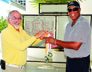 April Medals Sponsor -  Mr Tommy Astaphan hands over the medals to AGA vice president Mr Val Banks