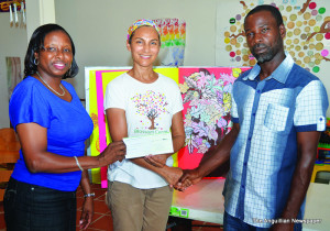 Ms. Stacie Ruan presenting Cheque to Mrs. Renuka Harrigan