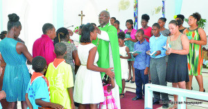 Bishop Brooks pronouncing blessing on children