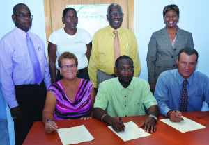 (Front row): Minister Jerome Roberts and Pastor Gareth Hodge (Chairman) and Ms Cora Richardson Hodge, Founder (back row, far right) with Bren Romney and Centre Personnel