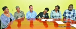 Mr Mario Bento signing contract with Chairman Mrs Marlene Brooks