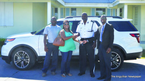 Commissioner presenting keys to vehicle winner