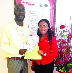 Text to win winner, Delano Mussington and Digicel's Marketing Executive  Roxanne Webster