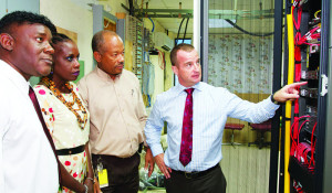  Digicel Business Solutions Director (Eastern Caribbean), Martin Keogh, explains to Acting QEH CEO, Louise Bobb, and QEH IT Manager, Cameron Connolly, how the Avaya-powered Unified Communication platform will benefit the medical and administrative staff while Digicel Barbados Strategic Business Development Director,Oliver Haynes, looks on