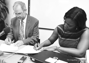 Signing of agreement by Mr. Kevin Clarke and Mrs. Chanelle Petty Barrett