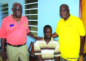 Rotarians Harris Richardson and Seymour Hodge with Tyrone Richardson