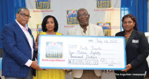 L-R: Mr. Anthony Jackson, Draw Manager; Ms. Paula Williams, Office Manager St. Maarten & Anguilla; Mr. Keith “Chinnix” Brooks, Winner and Ms. Shereen Walker, Regulator of Jamaica - BGLC