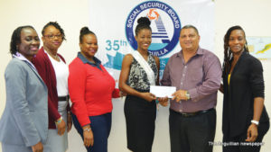 Mr. Timothy Hodge presents cheque to Ms. Dee-Ann Kentish Rogers