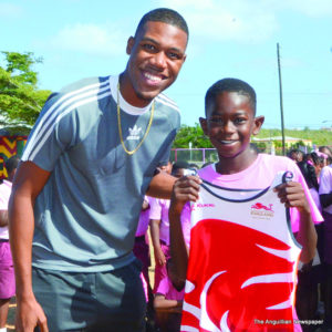 Zharnel Hughes presenting his jersey to  Joniff Gumbs