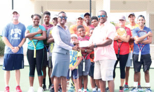 ATA’s Founder, CEO and President, Mitchelle V. Lake receiving sponsorship cheque from SSB’s Public Relations Officer, Rosanna Browne; coaches and camp participants of the  high performance group