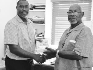 Minister Curtis Richardson making presentation to Bishop Errol Brooks