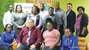 Facilitator Timothy Hodge (centre, seated) surrounded by a number of the Social Security Diploma programme participants