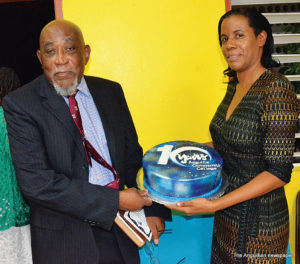 Dr. Delroy Louden and Mrs. Mary Smith with ACC anniversary cake