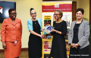 Representatives of UWI Press, Karen Smith and Donna Muirhead, present a collection of UWI Press publications to Ms. Therese Turner-Jones, General Manager, IDB Caribbean Group, as Dr. Luz Longsworth, Pro Vice-Chancellor and Campus Principal of The UWI Open Campus and Chair of the Board of UWI Press, looks on