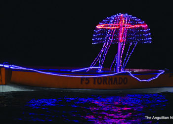 BOAT DISPLAYED WITH FESTIVE TRIMMINGS IN ISLAND HARBOUR BAY